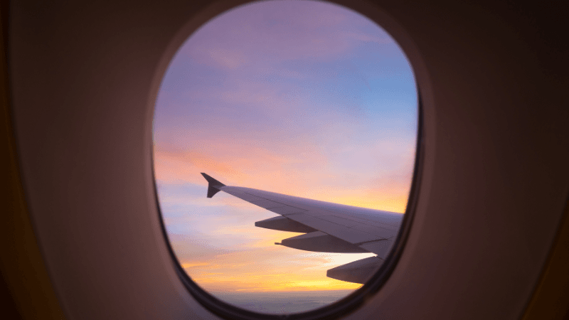 Airplane wing view from window seat during flight