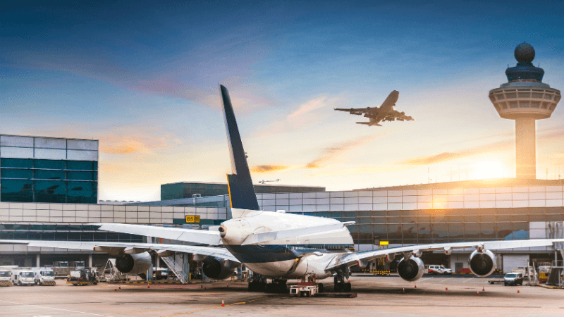 Large airport terminal with high ceilings and travelers