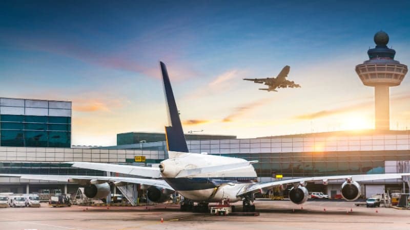 Large airport terminal with high ceilings and travelers